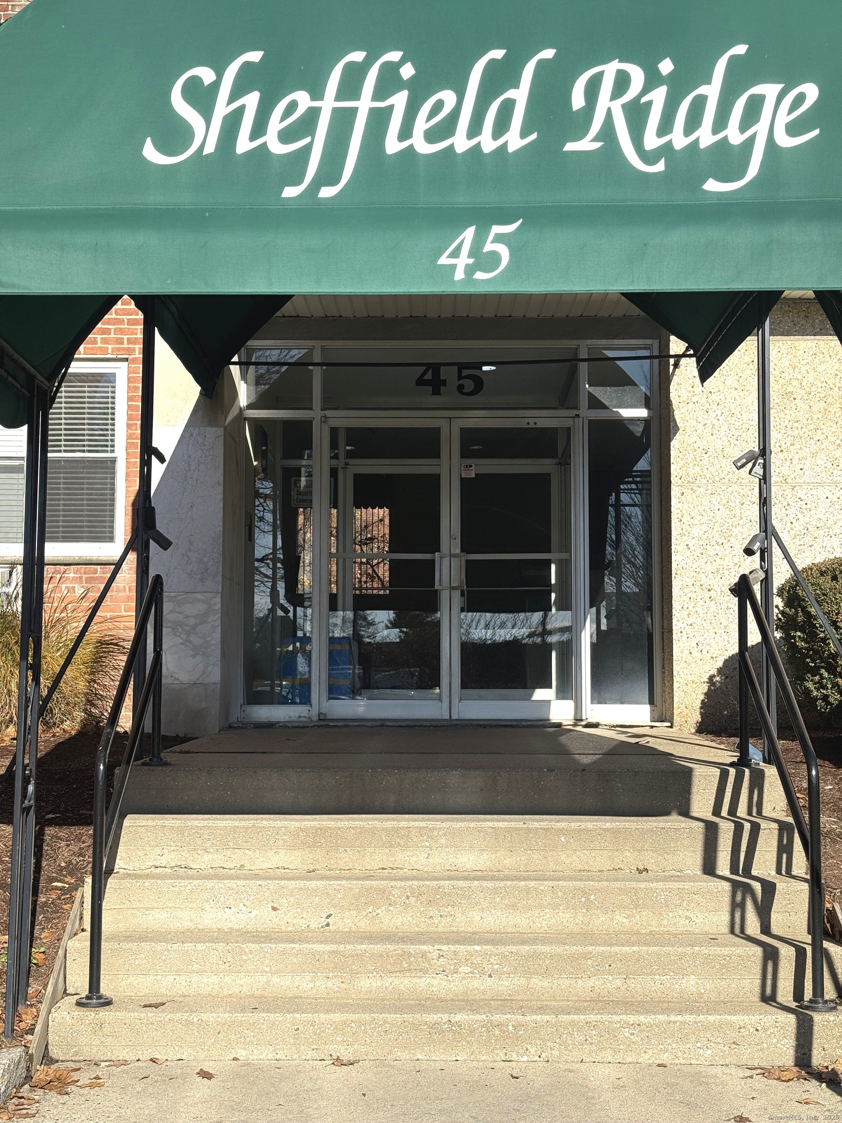 45 Maple Street, Unit 2E Norwalk, CT 06850 - Photo 2 of 16 a front view of a building with a sign board