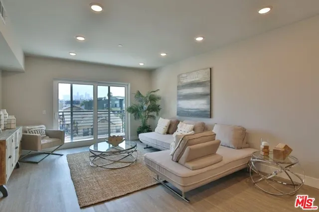 a living room with furniture and a floor to ceiling window