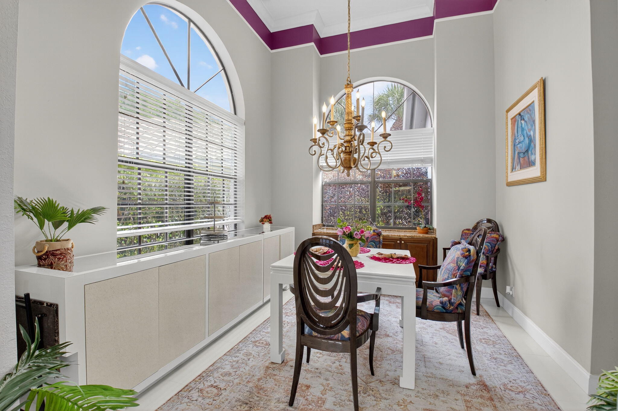 2423 Northwest 63rd Street Boca Raton, FL 33496 - Photo 11 of 83 a dining room with furniture a rug and a chandelier