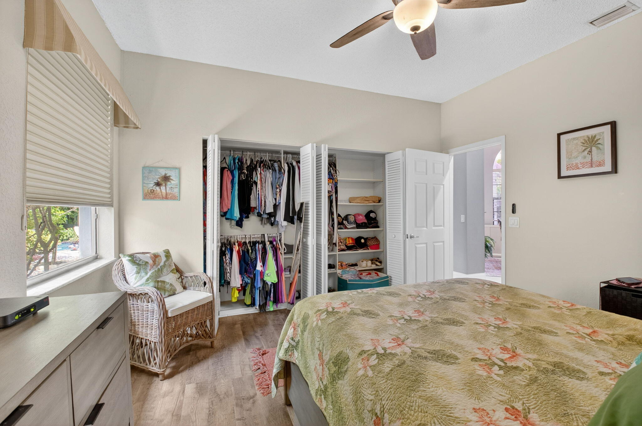 2423 Northwest 63rd Street Boca Raton, FL 33496 - Photo 19 of 83 a bedroom with a bed and a chandelier