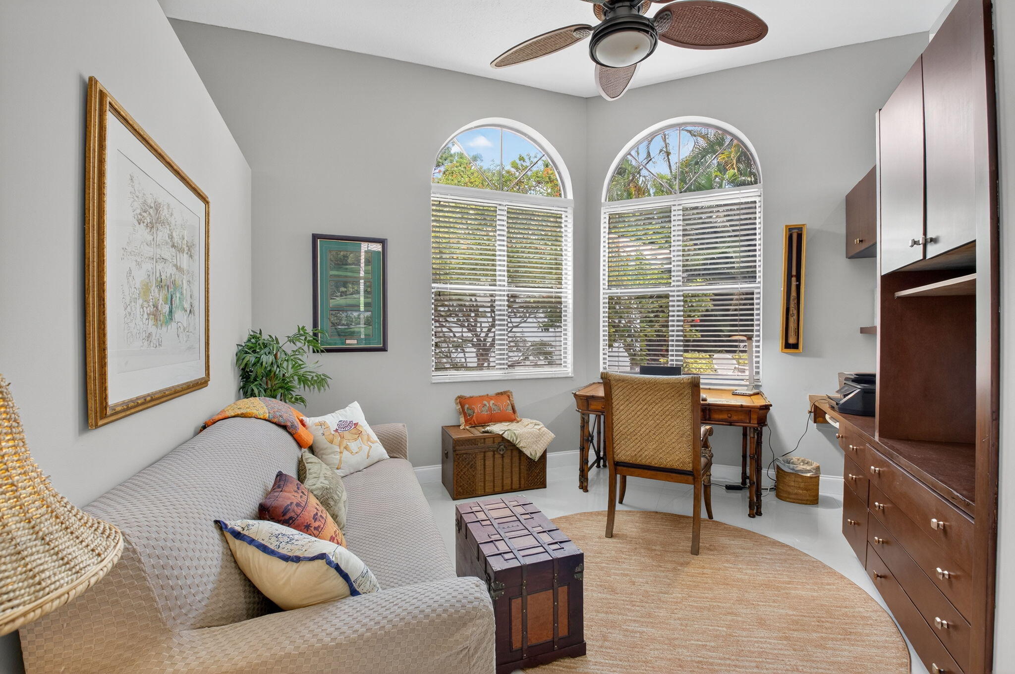 2423 Northwest 63rd Street Boca Raton, FL 33496 - Photo 22 of 83 a living room with furniture a flat screen tv and a large window