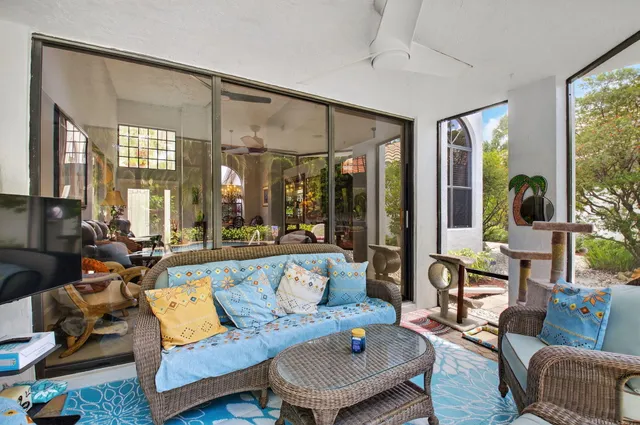 a view of backyard with seating area and trees in the background