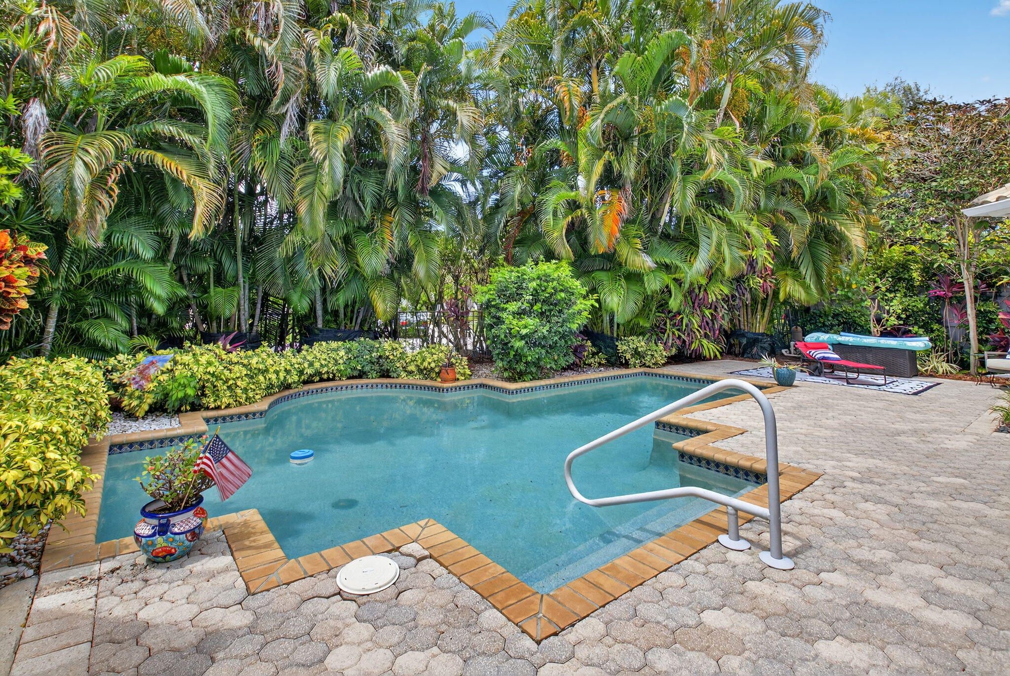 2423 Northwest 63rd Street Boca Raton, FL 33496 - Photo 32 of 83 a view of a backyard with plants and outdoor seating