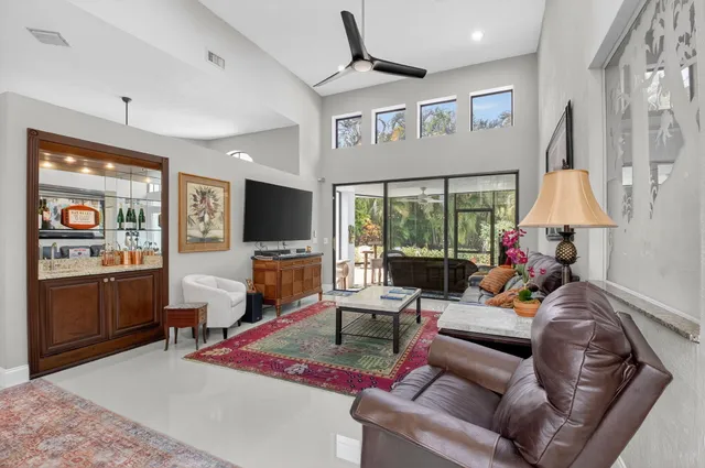 a living room with furniture a dining table and a painting