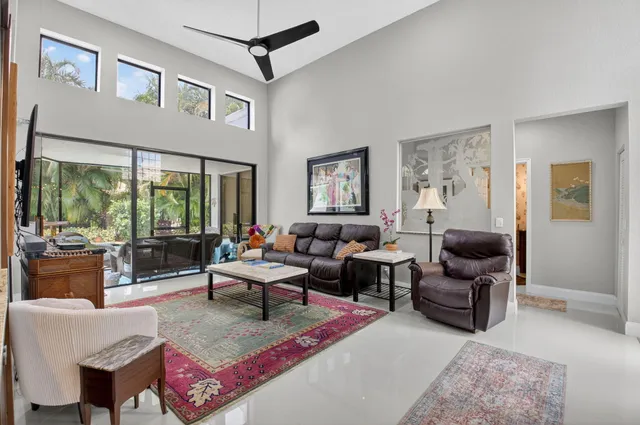 a dining room with furniture potted plants and a chandelier