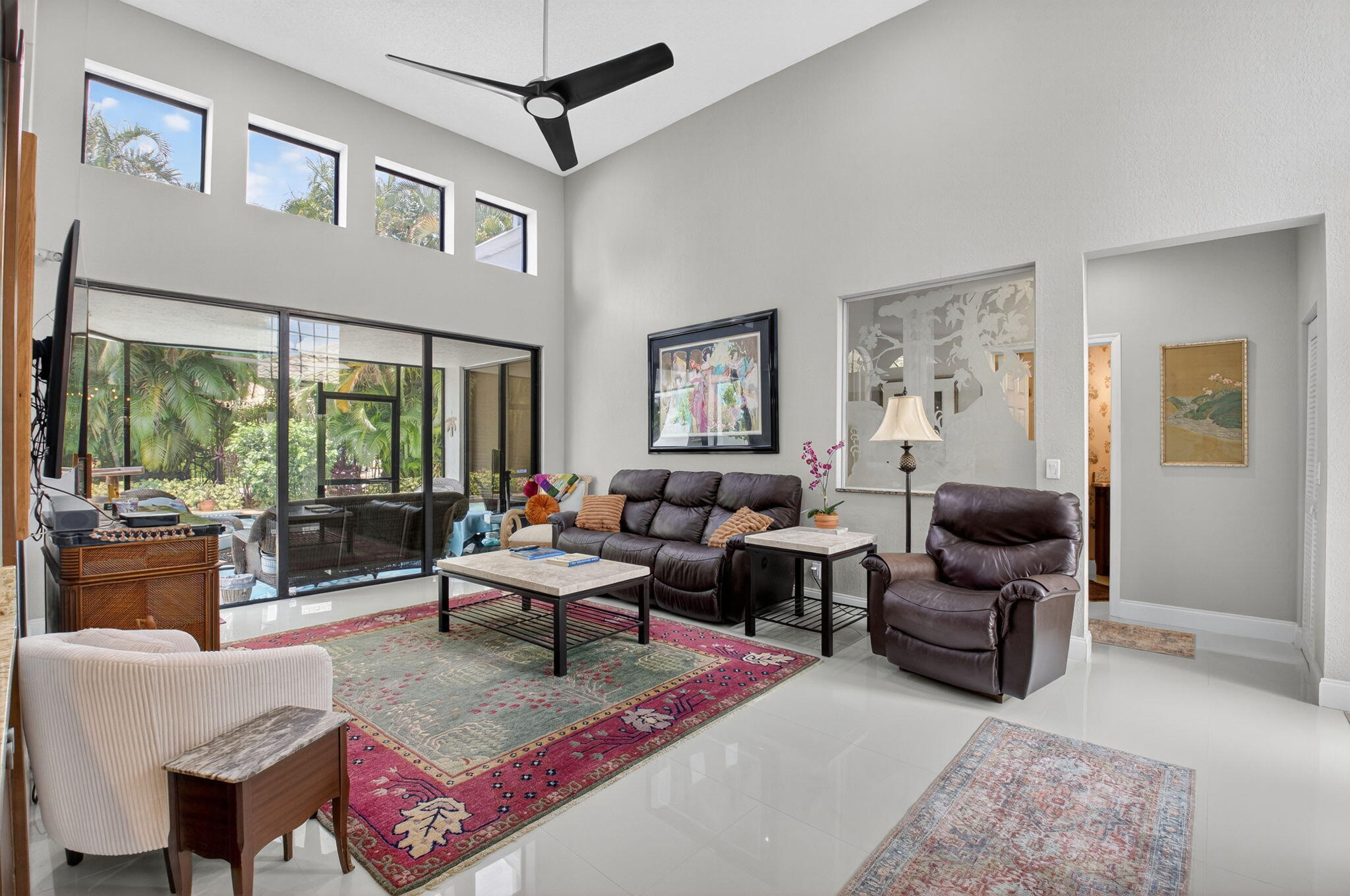 2423 Northwest 63rd Street Boca Raton, FL 33496 - Photo 7 of 83 a living room with furniture or couch and a flat screen tv