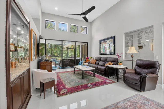a dining room with furniture a rug and a chandelier