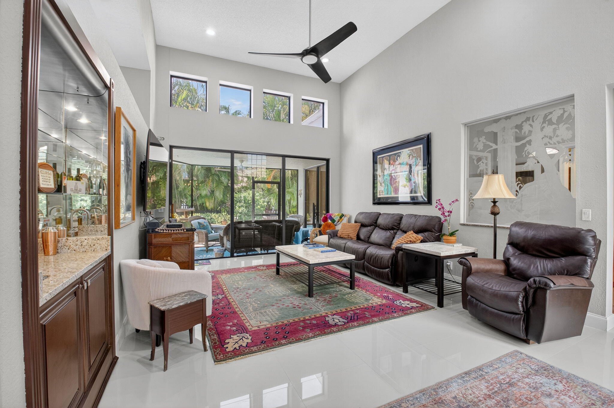 2423 Northwest 63rd Street Boca Raton, FL 33496 - Photo 8 of 83 a living room with furniture ceiling fan and a rug