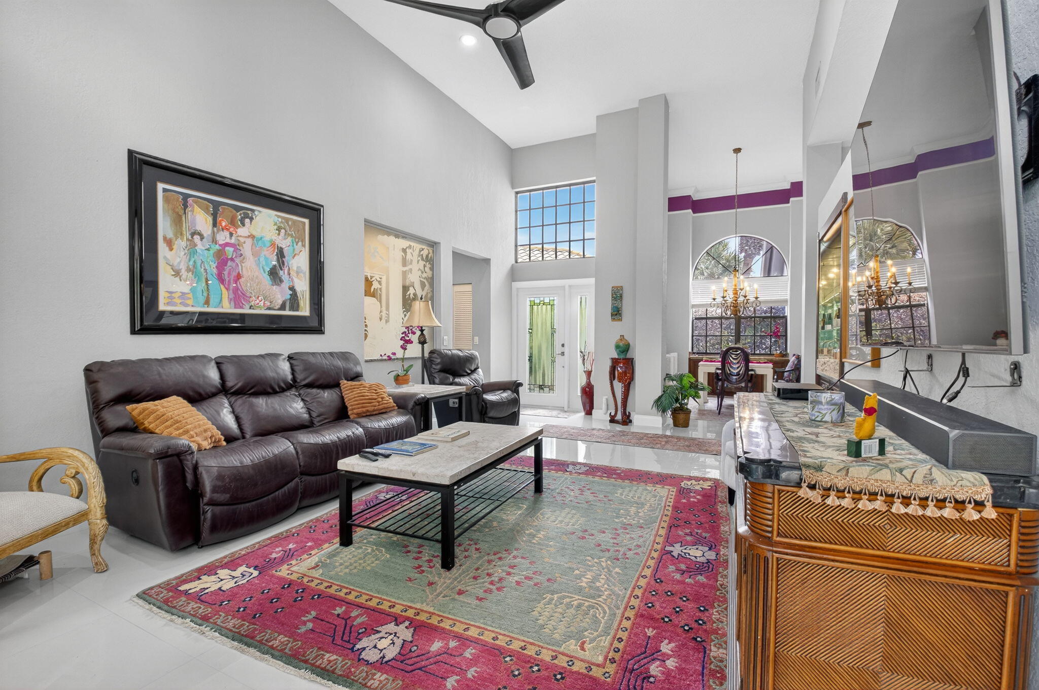 2423 Northwest 63rd Street Boca Raton, FL 33496 - Photo 9 of 83 a living room with furniture a dining table and a painting