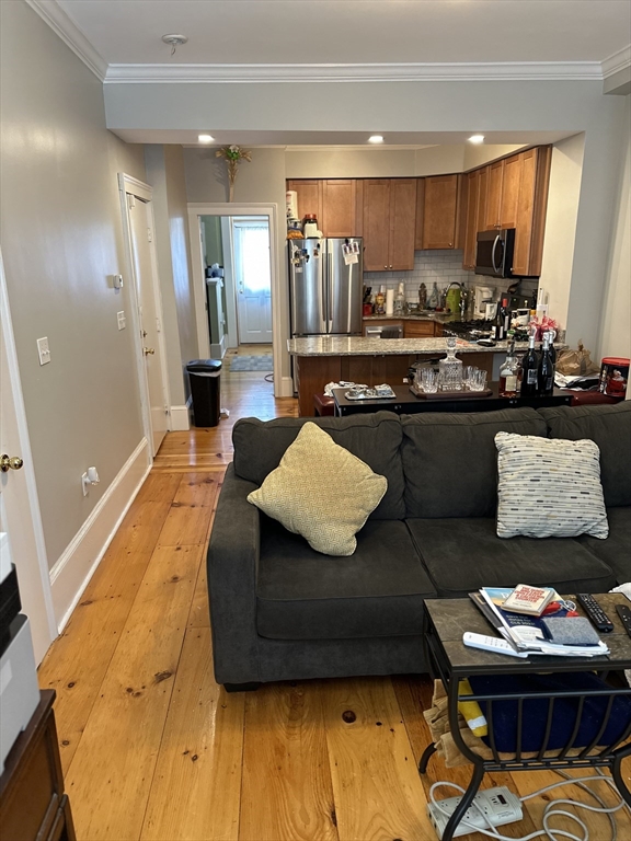 61 Putnam Street, Unit 2 Boston, MA 02128 - Photo 8 of 11 a living room with kitchen and a couch