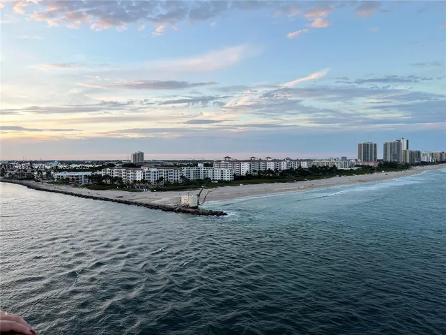 a view of a balcony with wooden floor and lake view