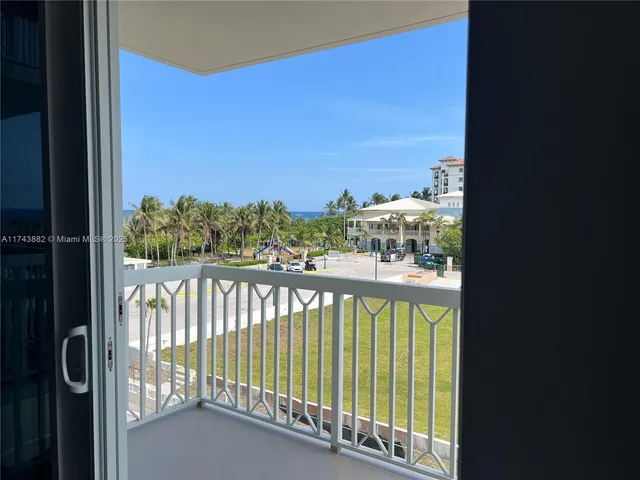 a bathroom with a sink a toilet a mirror and shower curtain