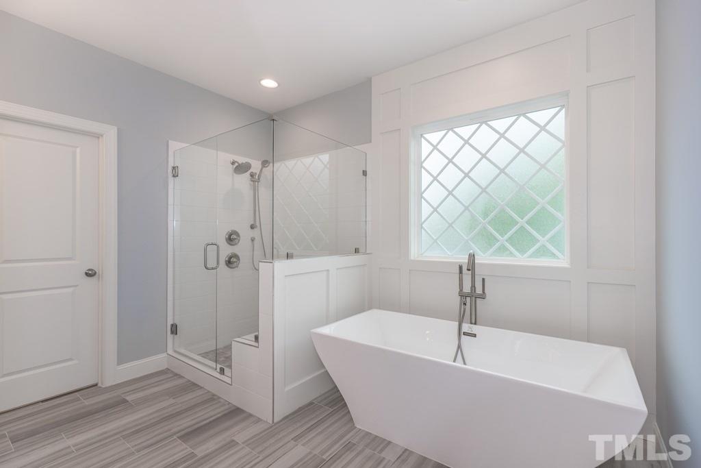 8000 Ghost Pony Trail Raleigh, NC 27613 - Photo 14 of 30 a bathroom with a bathtub and a shower