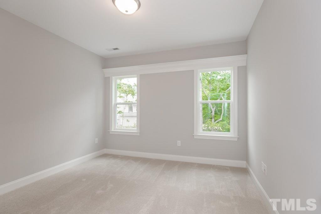 8000 Ghost Pony Trail Raleigh, NC 27613 - Photo 17 of 30 an empty room with windows