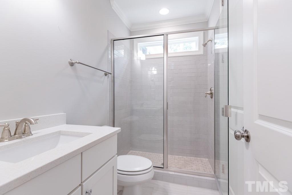 8000 Ghost Pony Trail Raleigh, NC 27613 - Photo 22 of 30 a bathroom with a granite countertop sink toilet and shower
