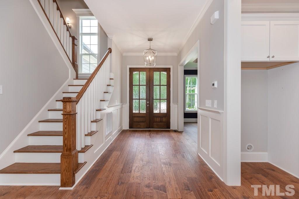 8000 Ghost Pony Trail Raleigh, NC 27613 - Photo 27 of 30 wooden floor with chandelier and windows