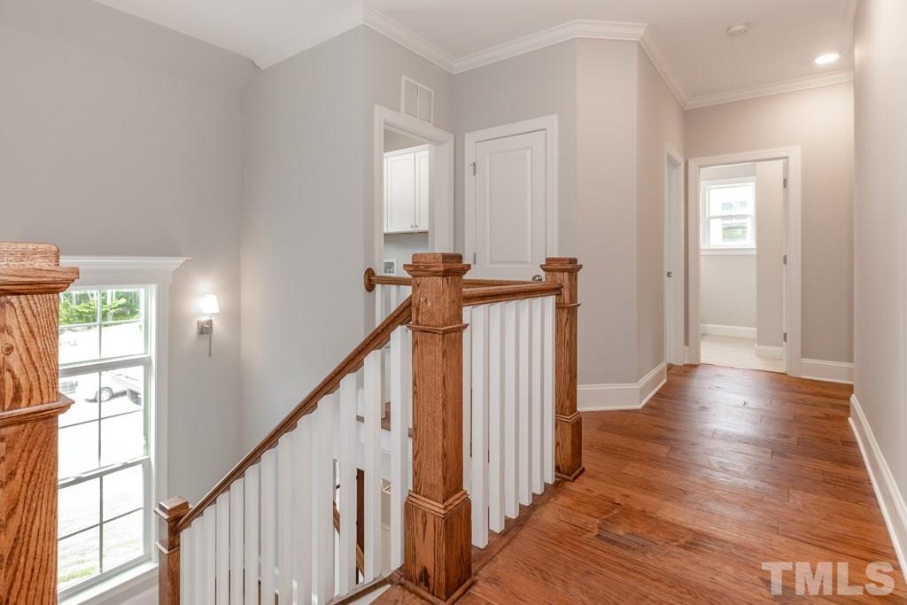 8000 Ghost Pony Trail Raleigh, NC 27613 - Photo 28 of 30 a view of a hallway with wooden floor and windows