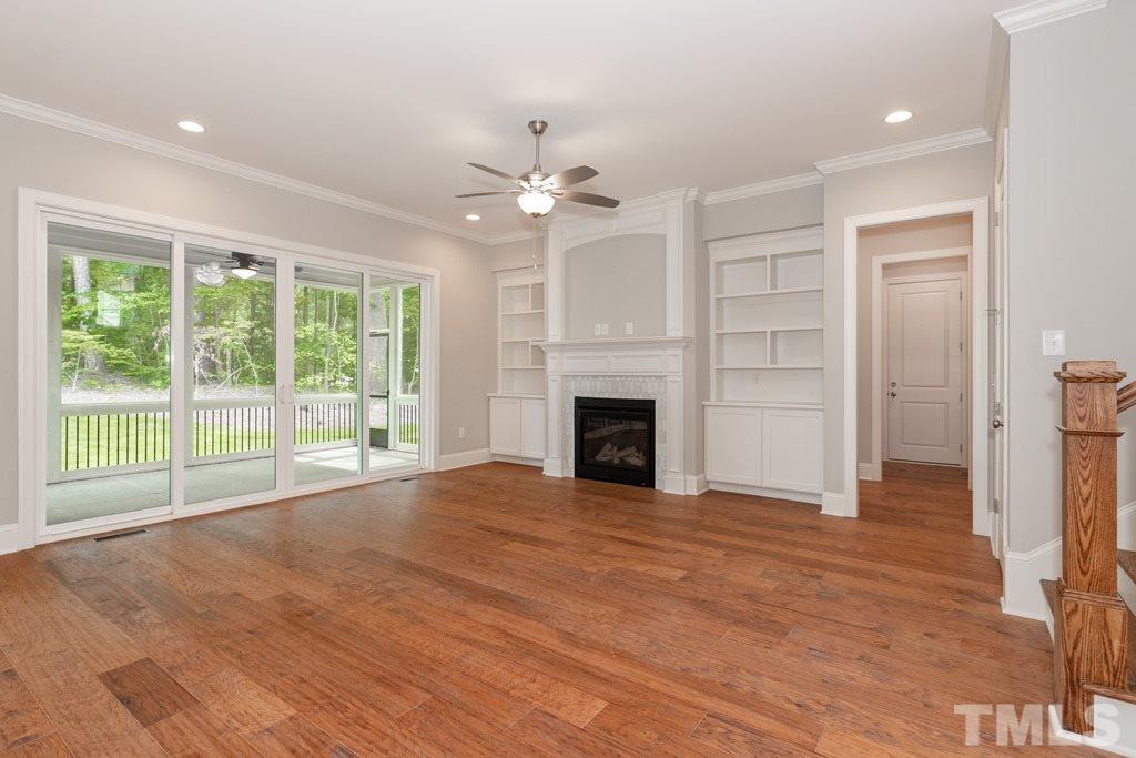 8000 Ghost Pony Trail Raleigh, NC 27613 - Photo 4 of 30 a view of empty room with wooden floor and fan