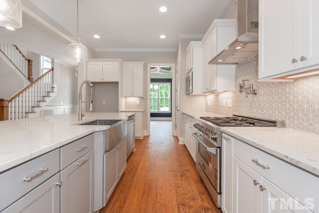 8000 Ghost Pony Trail Raleigh, NC 27613 - Photo 9 of 30 a large kitchen with cabinets and a stove