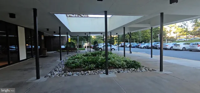a view of a patio with table and chairs under an umbrella