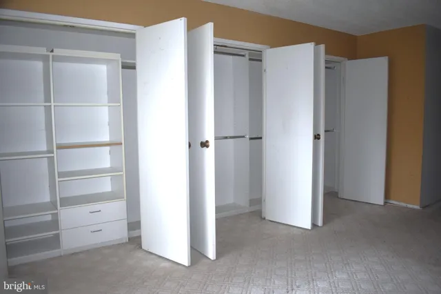 a view of closet area with empty racks