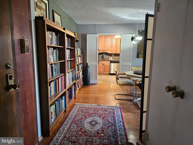 a view of a hallway with wooden floor and entryway