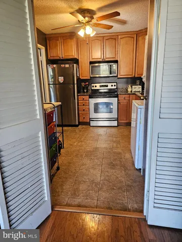 a kitchen with stainless steel appliances granite countertop a refrigerator and a stove