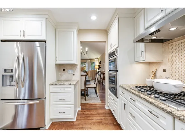 a kitchen with a refrigerator and a stove