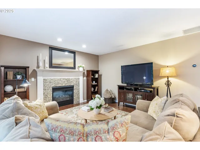 a living room with furniture a fireplace and a flat screen tv