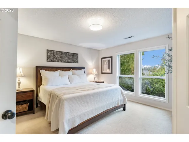 a bedroom with a large bed and a large window
