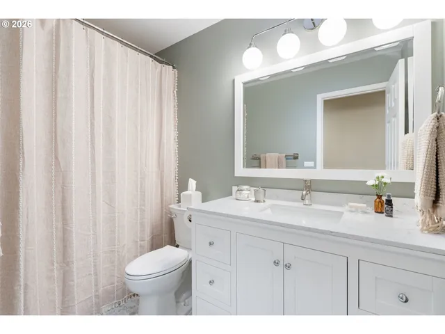 a bathroom with a toilet a sink and a mirror
