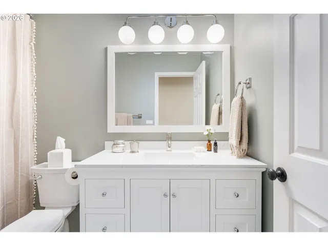 a bathroom with a sink vanity and a mirror