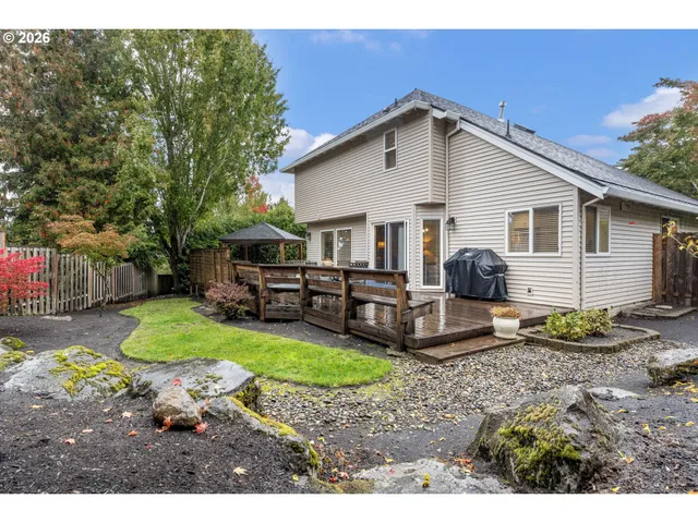 a backyard of a house with garden and barbeque oven