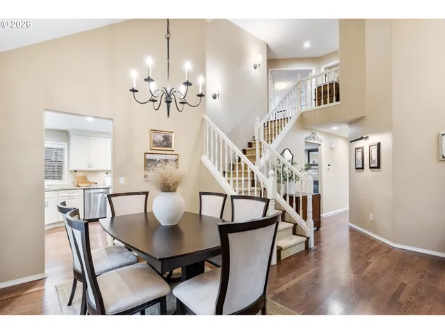 a view of a dining room with furniture and a chandelier