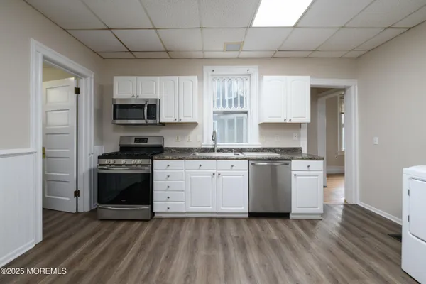 a kitchen with a stove a sink and a refrigerator