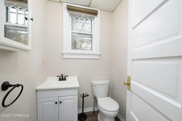 a white toilet sitting next to a bathroom sink