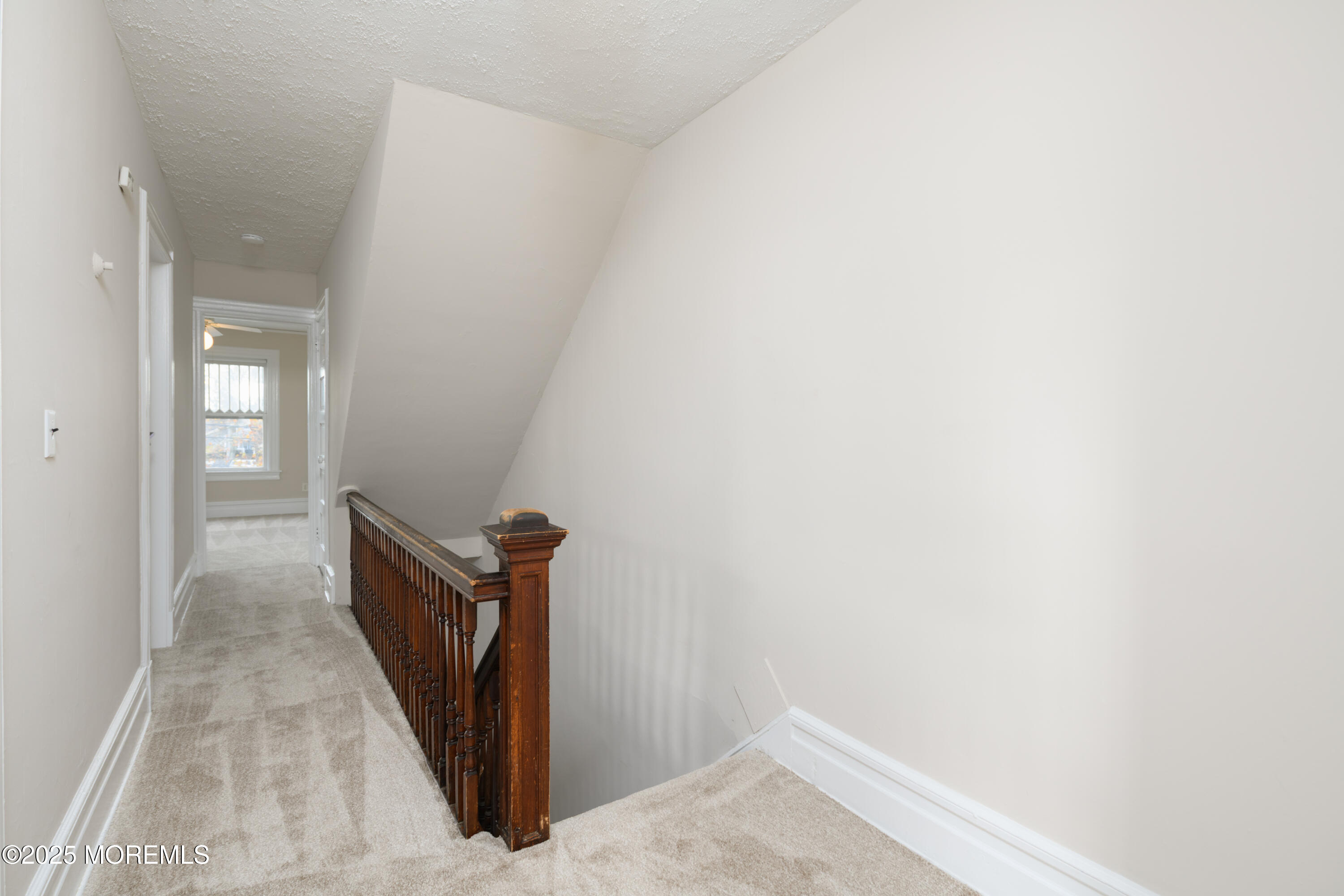 64 Harding Road Red Bank, NJ 07701 - Photo 17 of 23 a view of a hallway with wooden floor and a door