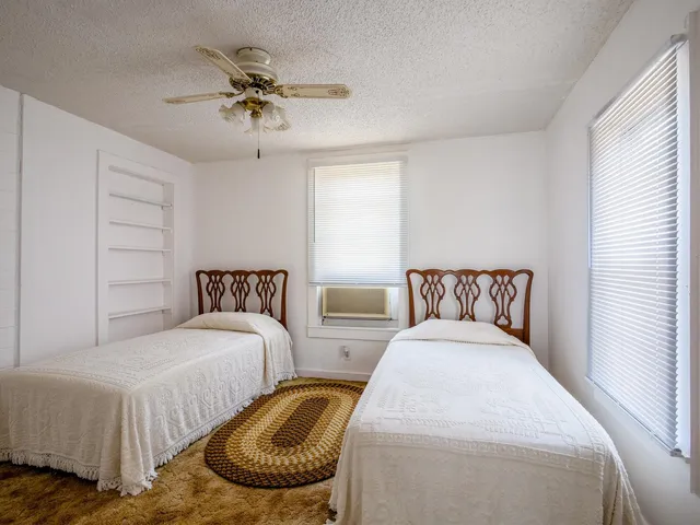 a bathroom with a sink a toilet and a window