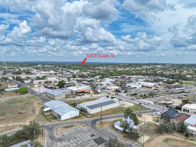an aerial view of residential houses with city view