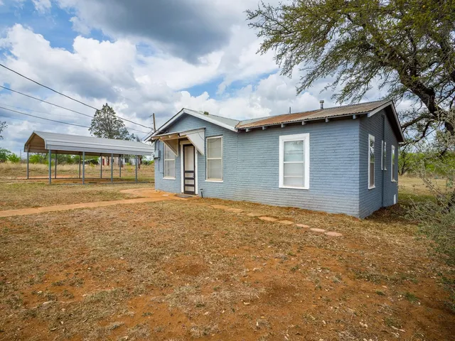 a house with trees in the background