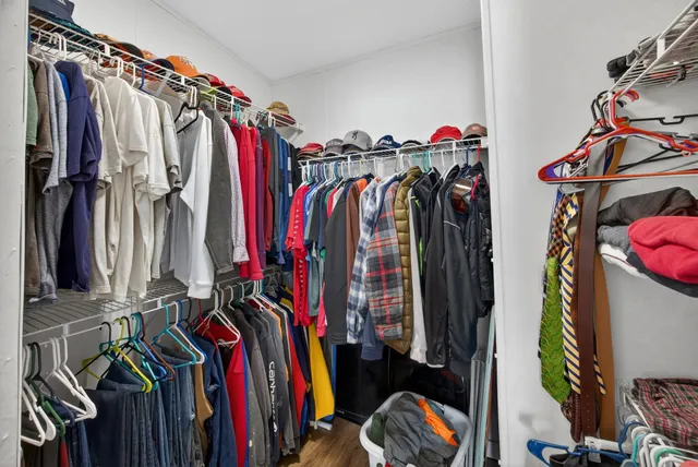 a view of walk in closet with clothes