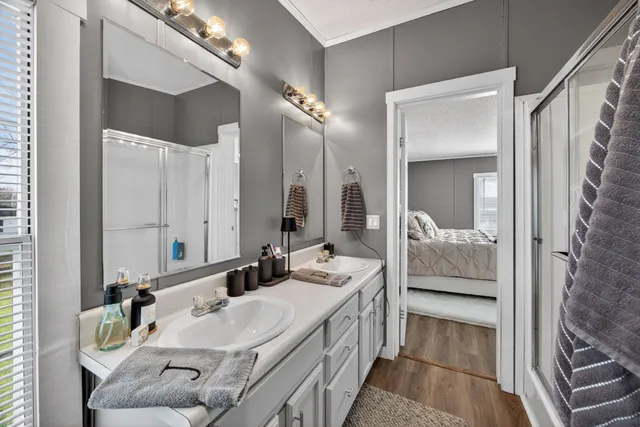 a en suite bathroom with a double vanity sink and a mirror