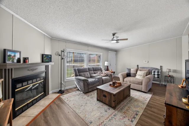 a living room with furniture and a fireplace