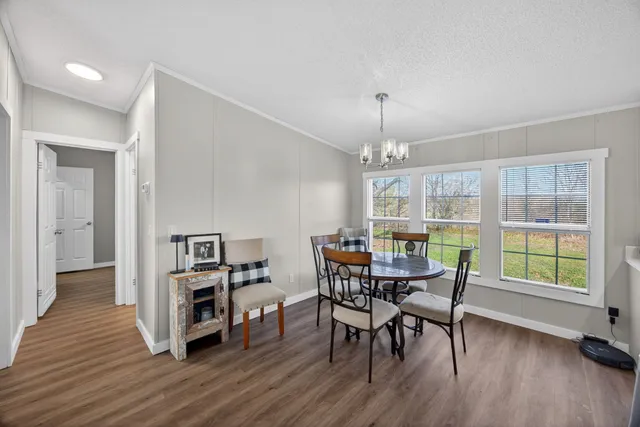 a view of a dining room with furniture and wooden floor
