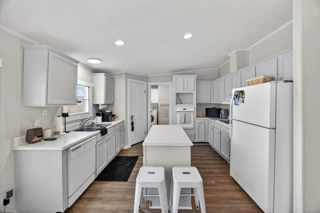 a kitchen with white cabinets and white appliances