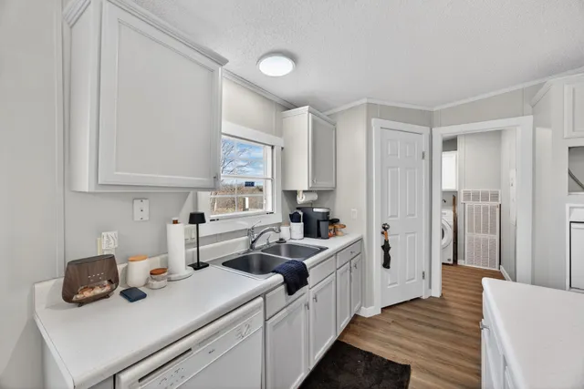 a kitchen with white cabinets and white appliances