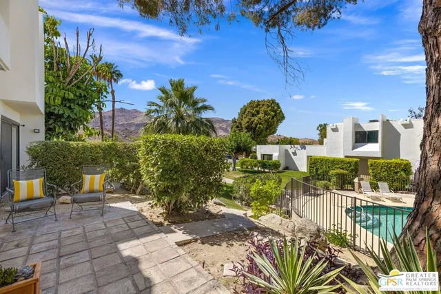 a large white kitchen with wooden floor