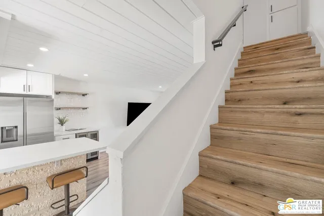 a bedroom with a bed and painting on the wall