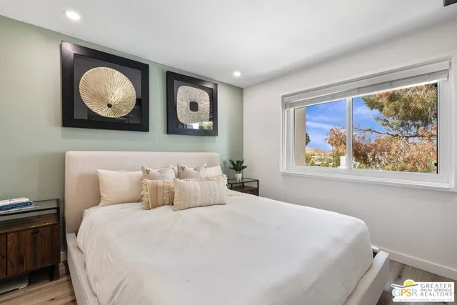 a bathroom with a sink a toilet a mirror and shower