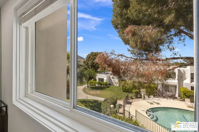 a bedroom with a large bed and a painting on the wall